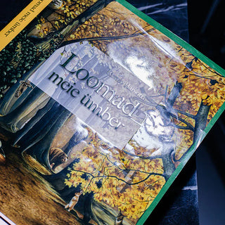 Book cover with high-shine gloss lamination reflecting light over a colorful illustration of a forest scene.