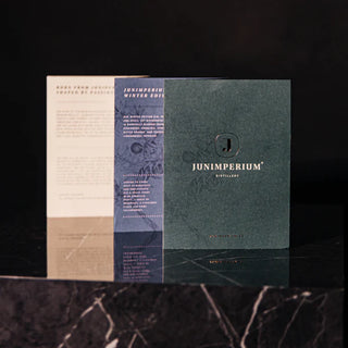 Brochures featuring bronze foil flyer printing on a dark green card.
