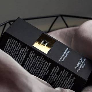 Luxurious custom gold foil packaging for hair product, featuring reflective gold metallic lettering on a matte black box.