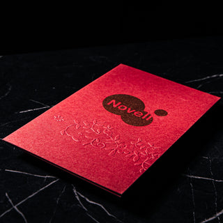 Custom embossed menu covers featuring red textured cardstock and blind embossing details.