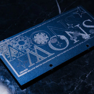 Blue cardstock featuring glitter screen printing of the word "SNOW" with silver snowflake and star illustrations.