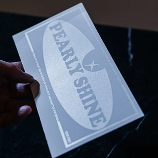 High-end pearlescent screen printing on a white card showing a shimmering, light-reflective 'Pearly Shine' finish.