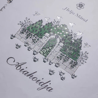 Detailed silver glitter screen print on a book cover featuring a shimmering garden gate and bird illustrations.